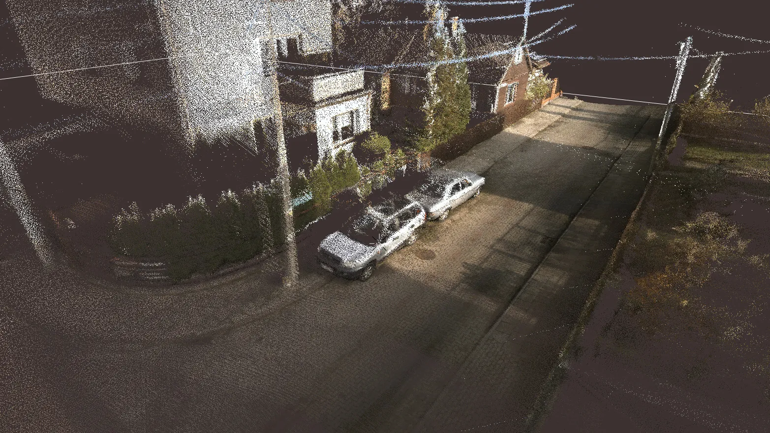 Point cloud of a street with buildings and cars